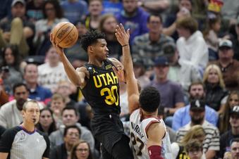 Utah Jazz guard Ochai Agbaji (30) passes the ball as Denver Nuggets guard Jamal Murray (27) defends during the first half of an NBA basketball game Saturday, April 8, 2023, in Salt Lake City. (AP Photo/Rick Bowmer)