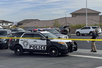 A SWAT team arrives to provide assistance as FBI agents negotiated with Matthew Beasley, who later was shot during the confrontation before being taken into custody,  March 3, 2022 in Las  Vegas.  Beasley, a  longtime Las Vegas attorney was indicted Wednesday on federal charges that he orchestrated a $460 million Ponzi scheme spanning multiple states, from Nevada and Utah to California and Arizona.(Bizuayehu Tesfaye/Las Vegas Review-Journal via AP)
