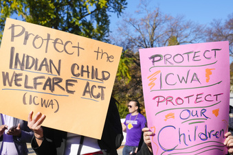 FILE - Demonstrators stand outside the U.S. Supreme Court in Washington, Nov. 9, 2022, as the court hears arguments over the Indian Child Welfare Act. North Dakota's Republican Gov. Doug Burgum has signed a bill into law to protect tribal cultures by codifying the federal Indian Child Welfare Act into state law, Burgum's office announced Monday, May 8, 2023. (AP Photo/Mariam Zuhaib, File)