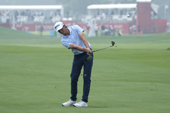 Peter Kuest hits his approach shot onto the 18th green during the first round of the Rocket Mortgage Classic golf tournament at Detroit Country Club, Thursday, June 29, 2023, in Detroit. (AP Photo/Carlos Osorio)