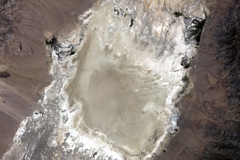 In this  undated photo provided by NASA, a satellite captures the Railroad Valley (RRV), a dry lakebed in Nevada, for conducting ground-based calibration of Earth-observing satellite instruments. At the request of NASA, U.S. land managers have withdrawn about 36 square miles of federal land otherwise open to mineral exploration and mining at the site 250 miles northeast of Las Vegas. Nevada Republican Rep. Mark Amodei has introduced legislation that would rescind the land withdrawal and potentially reopen it to mining. (NASA via AP)