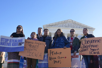 FILE- Demonstrators stand outside of the U.S. Supreme Court, as the court hears arguments over the Indian Child Welfare Act, Nov. 9, 2022, in Washington. The Supreme Court on Thursday, June 15, 2023, preserved the 1978 Indian Child Welfare Act, which gives preference to Native American families in foster care and adoption proceedings of Native children, rejecting a broad attack from Republican-led states and white families who argued it is based on race. (AP Photo/Mariam Zuhaib, File)
