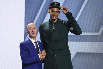 Victor Wembanyama poses for a photo with NBA commissioner Adam Silver after being selected first overall by the San Antonio Spurs during the NBA basketball draft, Thursday, June 22, 2023, in New York. (AP Photo/John Minchillo)