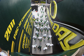 FILE - The Oregon football team walks through a tunnel before an NCAA college football game against South Dakota in Eugene, Ore., Saturday, Aug. 30, 2014. Dealing a crushing combination to the Pac-12 on Friday, Aug. 4, 2023, the Big Ten announced Oregon and Washington would be joining the conference next August, and the Big 12 completed its raid of the beleaguered league by adding Arizona, Arizona State and Utah.  (AP Photo/Ryan Kang, File)