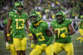 Oregon wide receiver Traeshon Holden (5) celebrates a touchdown against Hawaii with quarterback Ty Thompson (13) and offensive lineman Iapani Laloulu (72) during the second half of an NCAA college football game Saturday, Sept. 16, 2023, in Eugene, Ore. (AP Photo/Andy Nelson)