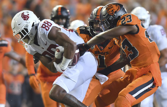 FILE - Oregon State's Ryan Cooper Jr. (23) attempts to strip the ball from Washington State's De'Zhaun Stribling (88) while Oregon State's Omar Speights (1) assists on the tackle during the first half of an NCAA college football game Saturday, Oct. 15, 2022, in Corvallis, Ore. Oregon State and Washington State are the last remaining members of the Pac-12 after this season and they have been fielding calls from the likes of the Mountain West and American Athletic conferences eager to discuss options. (AP Photo/Mark Ylen, File)