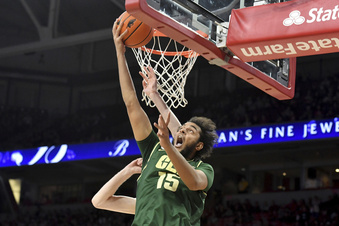 FILE - Charlotte forward Aly Khalifa (15) drives in for a layup against Arkansas during an NCAA college basketball game Tuesday, Dec. 7, 2021, in Fayetteville, Ark.  BYU bolstered its offense with the offseason additions of  Khalifa and Dawson Baker, from UC Irvine.  (AP Photo/Michael Woods, File)