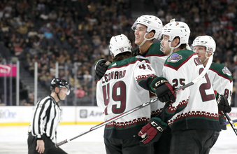 Arizona Coyotes defenseman Maveric Lamoureux, center, celebrates with forward John Leonard (49) and center Justin Kirkland (25) after scoring against the Vegas Golden Knights during the second period of a preseason NHL hockey game Friday, Sept. 29, 2023, in Las Vegas. (Steve Marcus/Las Vegas Sun via AP)