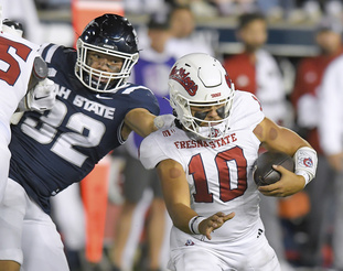 Utah State defensive end Paul Fitzgerald (32) sacks Fresno State quarterback Logan Fife (10) during the first half of an NCAA college football game Friday, Oct. 13, 2023, in Logan, Utah. (Eli Lucero/The Herald Journal via AP)