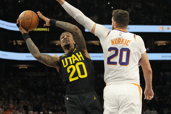 Utah Jazz forward John Collins (20) drives past Phoenix Suns center Jusuf Nurkic during the first half of an NBA basketball game Saturday, Oct. 28, 2023, in Phoenix. (AP Photo/Rick Scuteri)