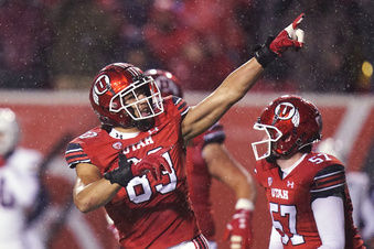 FILE - Utah defensive end Jonah Elliss (83) celebrates a fumble recovery against Arizona during the first half of an NCAA college football game Saturday, Nov. 5, 2022, in Salt Lake City. Luther Elliss earned consensus All-American honors as a senior at Utah in 1994 while helping lead his team to its first 10-win season in school history. Jonah Elliss has thrived under his father’s tutelage. He leads the Pac-12 with 10.0 sacks and 83 sack yards.(AP Photo/Rick Bowmer)