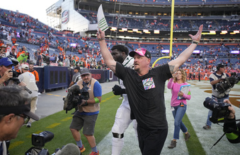 New York Jets offensive coordinator Nathaniel Hackett, front center, who was fired from the head coaching job of the Denver Broncos last year, celebrates as he leaves the field with offensive tackle Mekhi Becton after defeating the Broncos in an NFL football game Sunday, Oct. 8, 2023, in Denver. (AP Photo/David Zalubowski)