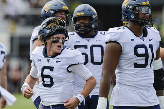 West Virginia quarterback Garrett Greene (6) watches as his touchdown is reviewed  during the first half of an NCAA college football game Central Florida, Saturday, Oct. 28, 2023, in Orlando, Fla. (AP Photo/Kevin Kolczynski)