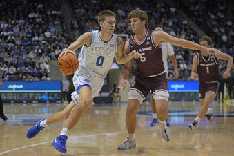 BYU forward Noah Waterman (0) drives as Bellarmine guard Peter Suder (5) defends during the first half of an NCAA college basketball game Friday, Dec. 22, 2023, in Provo, Utah. (AP Photo/Rick Bowmer)