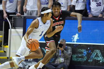 BYU guard Trey Stewart (1) drives on Denver guard Isaiah Addo-Ankrah (32) during the first half of an NCAA college basketball game Wednesday, Dec. 13, 2023, in Provo, Utah. (AP Photo/George Frey)