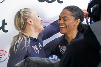 Third placed Kaillie Humphries and Kaysha Love of USA celebrate after their second run of the two-woman Bobsleigh World Cup race in Sigulda, Latvia, Sunday, Feb. 19, 2023.  Love is moving from push athlete to driver for the U.S. and will make her World Cup debut as a pilot next month with hopes of moving closer to a spot in the 2026 Olympics. (AP Photo/Oksana Dzadan, File)