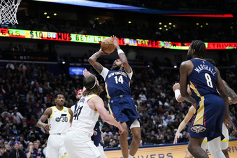 New Orleans Pelicans forward Brandon Ingram (14) shoots between Utah Jazz forward Kelly Olynyk (41) and guard Ochai Agbaji (30) in the second half of an NBA basketball game in New Orleans, Thursday, Dec. 28, 2023. The Pelicans won 112-105. (AP Photo/Gerald Herbert)