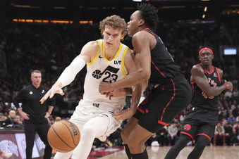 Utah Jazz forward Lauri Markkanen (23) drives against Toronto Raptors forward Scottie Barnes (4) during first-half NBA basketball game action in Toronto, Saturday, Dec. 23, 2023. (Chris Young/The Canadian Press via AP)