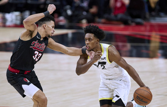 Utah Jazz guard Collin Sexton, right, dribbles past Portland Trail Blazers forward Toumani Camara during the second half of an NBA basketball game in Portland, Ore., Thursday, Dec. 14, 2023. (AP Photo/Craig Mitchelldyer)