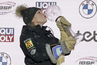 FILE - Overall World Cup winner Kaillie Humphries of United States celebrates during award ceremony for the women's monobob World Cup race in Sigulda, Latvia, Saturday, Feb. 18, 2023. Three-time Olympic gold medalist Kaillie Humphries of the U.S. announced Monday, Dec. 4, 2023, that she is missing this season because she and her husband are expecting their first child, due in June. (AP Photo/Oksana Dzadan, File)