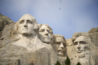 FILE -Visitors take in the massive sculpture carved into Mount Rushmore at the Mount Rushmore National Memorial Thursday, Sept. 21, 2023, in, Keystone, S.D. Fewer planes and helicopters will be flying tourists over Mount Rushmore and other national monuments and parks as new regulations take effect that are intended to protect the serenity of some of the nation's most beloved natural areas.(AP Photo/David Zalubowski, File)