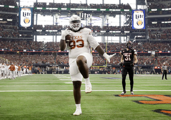 Texas Longhorns defensive lineman T'Vondre Sweat (93) strikes a pose in the end zone after catching a touchdown pass from quarterback Quinn Ewers during the first quarter of the Big 12 Championship NCAA college football game against Oklahoma State at AT&T Stadium in Arlington, Texas, Saturday, Dec. 2, 2023. (Tom Fox/The Dallas Morning News via AP)