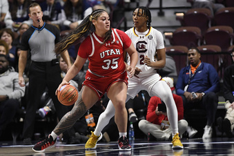 Utah forward Alissa Pili (35) is guarded by South Carolina forward Ashlyn Watkins (2) in the first half of an NCAA college basketball game, Sunday, Dec. 10, 2023, in Uncasville, Conn. (AP Photo/Jessica Hill)