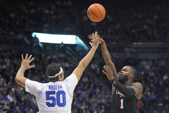 Houston guard Jamal Shead (1) shoots as BYU center Aly Khalifa (50) defends during the first half of an NCAA college basketball game Tuesday, Jan. 23, 2024, in Provo, Utah. (AP Photo/Rick Bowmer)