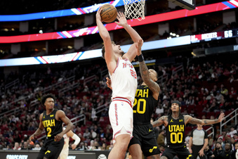 Houston Rockets center Alperen Sengun (28) shoots as Utah Jazz forward John Collins, right, defends during the first half of an NBA basketball game Saturday, Jan. 20, 2024, in Houston. (AP Photo/Eric Christian Smith)