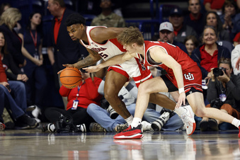 Arizona guard KJ Lewis (5) controls the ball against Utah guard Cole Bajema during the first half of an NCAA college basketball game Saturday, Jan. 6, 2024, in Tucson, Ariz. (AP Photo/Chris Coduto)