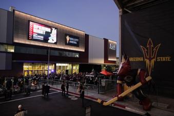 FILE - Arizona Coyotes fans wait for the doors to open prior to the Coyotes' home-opening NHL hockey game against the Winnipeg Jets at Mullett Arena in Tempe, Ariz., Oct. 28, 2022. The uncertain future of the Arizona Coyotes is a hot topic at NHL All-Star Weekend. They are playing their second season in a 5,000-seat arena on Arizona State's campus in Tempe.  (AP Photo/Ross D. Franklin, File)