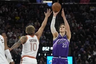 Utah Jazz forward Lauri Markkanen (23) shoots as San Antonio Spurs forward Jeremy Sochan (10) defends during the first half of an NBA basketball game Sunday, Feb. 25, 2024, in Salt Lake City. (AP Photo/Rick Bowmer)