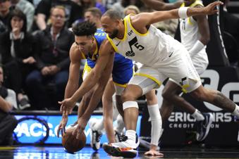 Golden State Warriors forward Trayce Jackson-Davis, left, battles with Utah Jazz guard Talen Horton-Tucker (5) for the ball during the first half of an NBA basketball game Thursday, Feb. 15, 2024, in Salt Lake City. (AP Photo/Rick Bowmer)