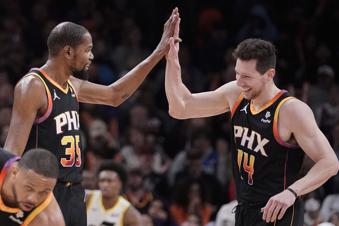 Phoenix Suns' Kevin Durant (35) and Drew Eubanks (14) high-five during the second half of an NBA basketball game against the Utah Jazz in Phoenix Thursday, Jan. 8, 2024. (AP Photo/Darryl Webb)