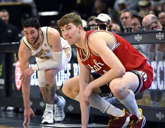 Utah forward Lawson Lovering, right, who used to play for Colorado, waits to check in as he makes his first appearance back in Boulder, Colo., in the first half of an NCAA college basketball game against Colorado, Saturday, Feb. 24, 2024. (AP Photo/Cliff Grassmick)