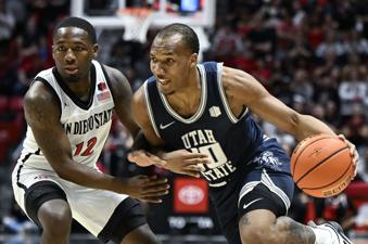 Utah State guard Darius Brown II (10) drives past San Diego State guard Darrion Trammell (12) during the first half of an NCAA college basketball game Saturday, Feb. 3, 2024, in San Diego. (AP Photo/Denis Poroy)