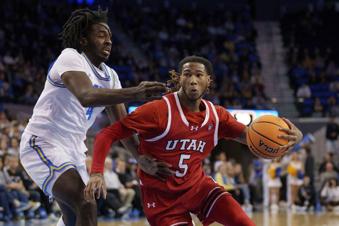 Utah guard Deivon Smith (5) drives against UCLA guard Will McClendon (4) during the first half of an NCAA college basketball game, Sunday, Feb. 18, 2024, in Los Angeles. (AP Photo/Eric Thayer)