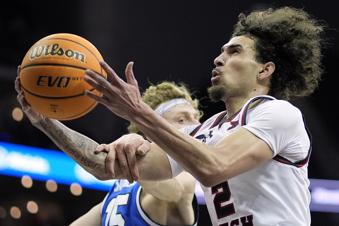 Texas Tech guard Pop Isaacs (2) shoots under pressure from BYU guard Richie Saunders (15) during the second half of an NCAA college basketball game in the quarterfinal round of the Big 12 Conference tournament, Thursday, March 14, 2024, in Kansas City, Mo. (AP Photo/Charlie Riedel)