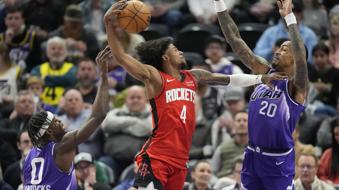 Houston Rockets guard Jalen Green (4) goes to the basket as Utah Jazz's Taylor Hendricks (0) and John Collins (20) defend during the first half of an NBA basketball game Friday, March 29, 2024, in Salt Lake City. (AP Photo/Rick Bowmer)