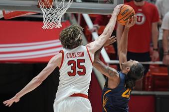 Utah center Branden Carlson (35) blocks a shot by California guard Jaylon Tyson (20) during the second half of an NCAA college basketball game Saturday, March 2, 2024, in Salt Lake City. (AP Photo/Rick Bowmer)