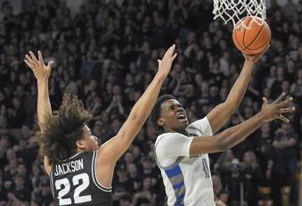 Air Force guard Byron Brown (11) drives to the basket as Utah State guard Javon Jackson (22) defends during the first half of an NCAA college basketball game Friday, March. 1, 2024, in Logan, Utah. (Eli Lucero/The Herald Journal via AP)