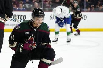 Arizona Coyotes right wing Dylan Guenther (11) celebrates his goal against the Vancouver Canucks during the third period of an NHL hockey game Wednesday, April 3, 2024, in Tempe, Ariz. (AP Photo/Ross D. Franklin)