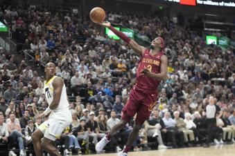 Cleveland Cavaliers guard Caris LeVert (3) goes to the basket as Utah Jazz guard Kris Dunn (11) looks on in the first half of an NBA basketball game Tuesday, April 2, 2024, in Salt Lake City. (AP Photo/Rick Bowmer)