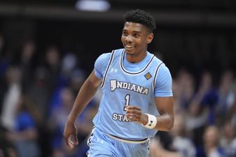 Indiana State guard Julian Larry celebrates after making a three-point basket in the second half of an NCAA college basketball game against Utah in the semifinals of the NIT, Tuesday, April 2, 2024, in Indianapolis. Indiana State won 100-90. (AP Photo/Michael Conroy)