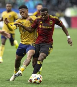 Seattle Sounders defender Nouhou Tolo dribbles the ball upfield as Real Salt Lake midfielder Nelson Palacio goes for the ball during the first half of an MLS soccer match Wednesday, May 29, 2024, in Seattle. (Nick Wagner/The Seattle Times via AP)