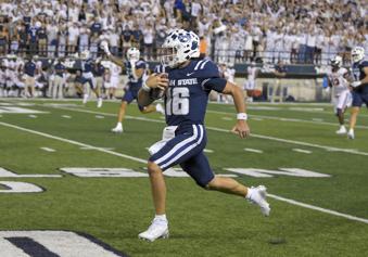 Utah State quarterback Bryson Barnes (16) runs for a 63-yard touchdown against Robert Morris in the second half of an NCAA college football game Saturday, Aug. 31, 2024, in Logan, Utah. (Eli Lucero/The Herald Journal via AP)