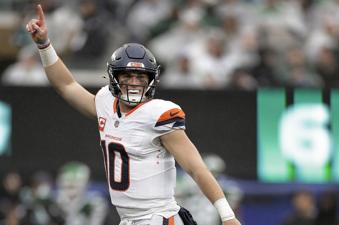 Denver Broncos quarterback Bo Nix (10) reacts after throwing his first touchdown pass against the New York Jets during the third quarter of an NFL football game, Sunday, Sept. 29, 2024, in East Rutherford, N.J. (AP Photo/Adam Hunger)