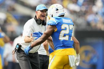 Los Angeles Chargers running back J.K. Dobbins (27) is congratulated by head coach Jim Harbaugh after scoring against the Las Vegas Raiders during the second half of an NFL football game, Sunday, Sept. 8, 2024, in Inglewood, Calif. (AP Photo/Ashley Landis)