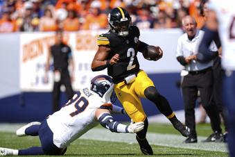 Pittsburgh Steelers quarterback Justin Fields (2) runs against Denver Broncos defensive end Zach Allen (99) during the first half of an NFL football game, Sunday, Sept. 15, 2024, in Denver. (AP Photo/David Zalubowski)