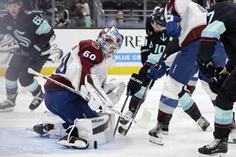 Colorado Avalanche goaltender Justus Annunen blocks the puck shot by Seattle Kraken center Matty Beniers (10) during the third period of an NHL hockey game, Tuesday, Oct. 22, 2024, in Seattle. The Avalanche won 3-2. (AP Photo/John Froschauer)